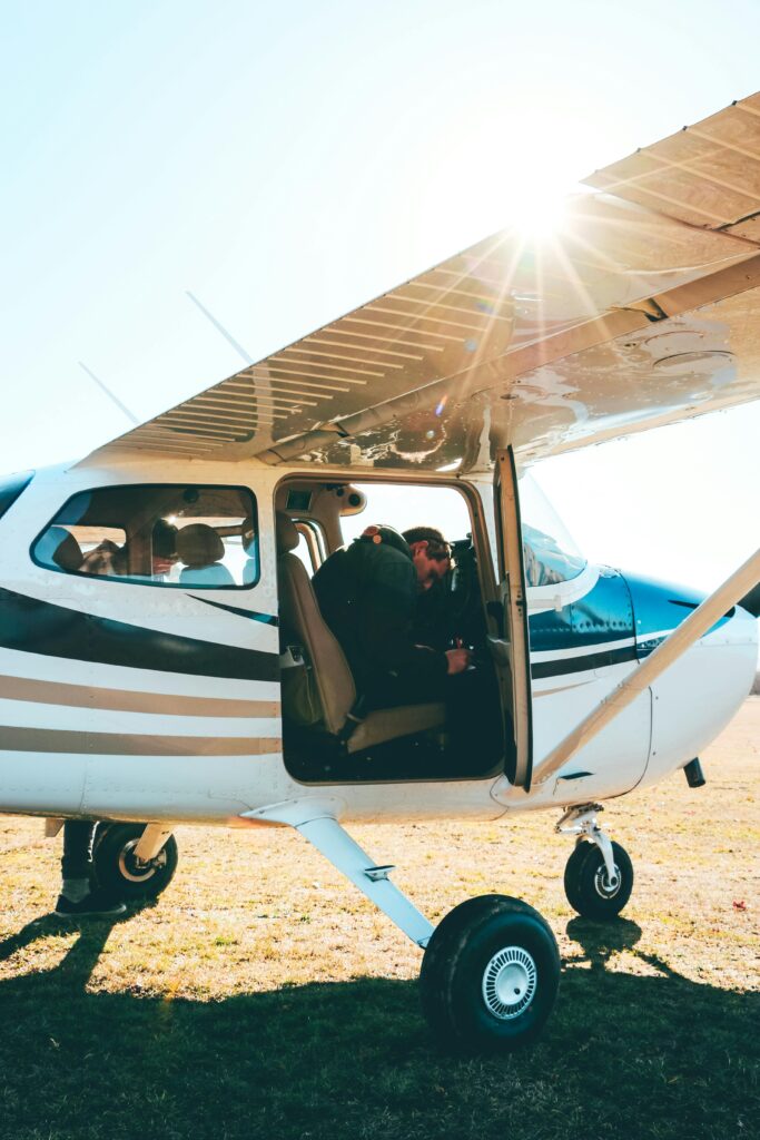pexels-photo-8714393-8714393 A pilot in a light aircraft preparing for takeoff under bright Canterbury sunlight.